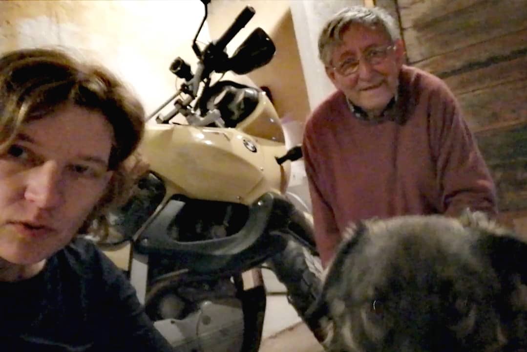two people, one dog, one motorbike